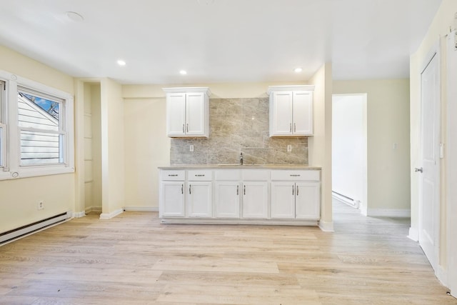 292 W 17th St, Chicago Heights, IL 60411 - kitchen with tasteful backsplash, white cabinetry, light countertops, light wood-style flooring, and a sink