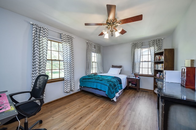 1628 Westminster Dr, Naperville, IL 60563 - bedroom featuring light wood-style flooring, an office area, baseboards, and a ceiling fan