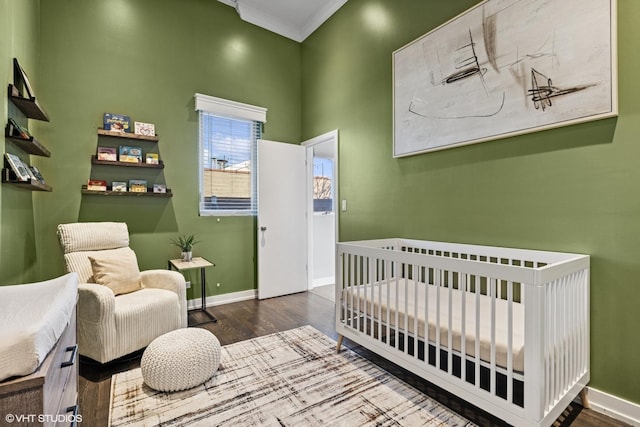 1625 W Barry Ave Unit 3, Chicago, IL 60657 - bedroom featuring wood finished floors, ornamental molding, baseboards, and a crib