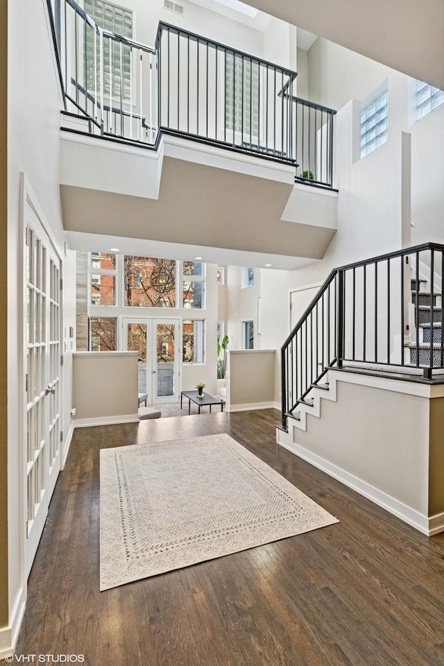 1625 W Barry Ave Unit 3, Chicago, IL 60657 - foyer entrance featuring a towering ceiling, stairway, wood finished floors, baseboards, and french doors