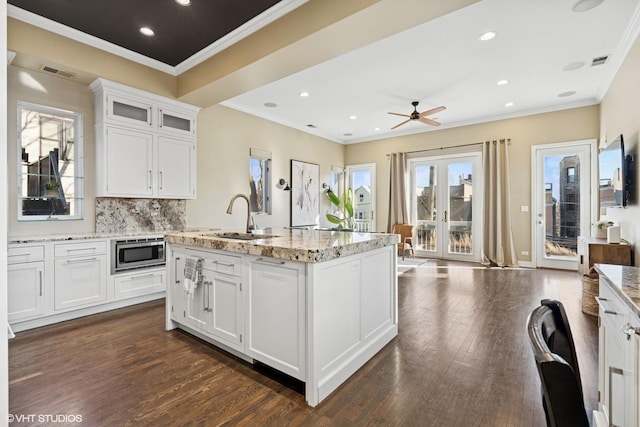 1625 W Barry Ave Unit 3, Chicago, IL 60657 - kitchen with stainless steel microwave, a sink, ceiling fan, dark wood-type flooring, and white cabinets