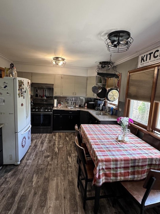 dining area featuring ornamental molding and dark wood-style flooring