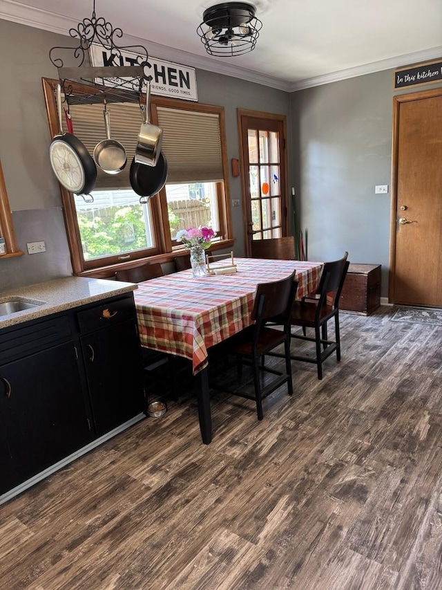 dining space featuring dark wood-type flooring and ornamental molding