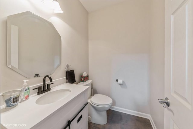 bathroom featuring vanity, toilet, tile patterned flooring, and baseboards