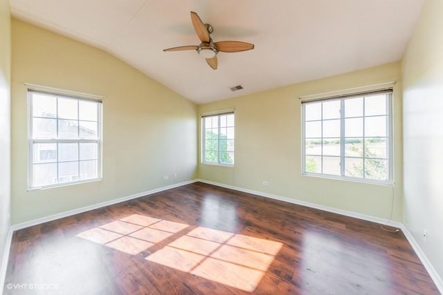 spare room featuring ceiling fan, vaulted ceiling, wood finished floors, and baseboards