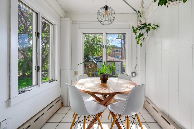 dining room featuring baseboard heating and light tile patterned floors