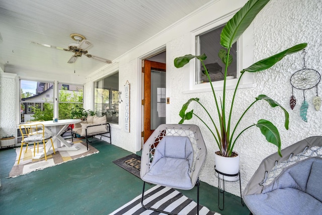 sunroom featuring a ceiling fan