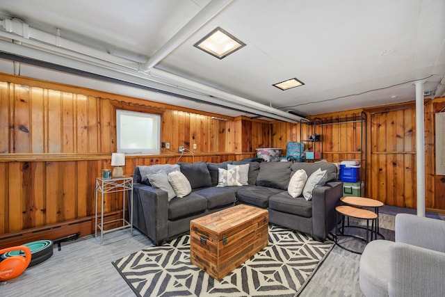 living room with light wood finished floors and wooden walls