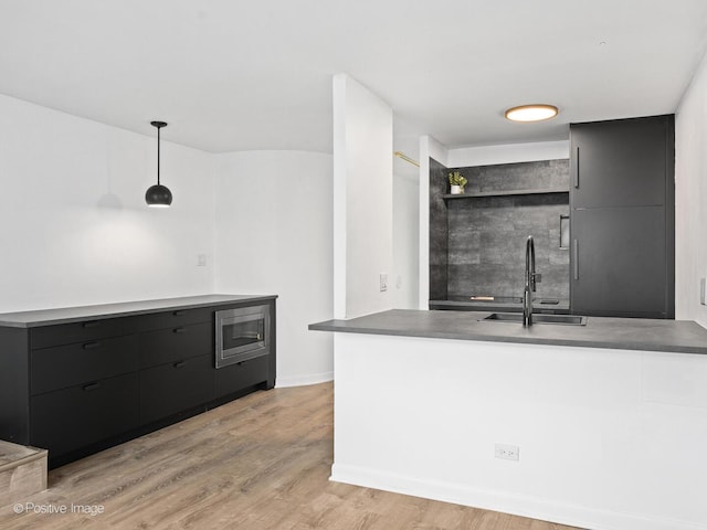 1221 N Dearborn St Unit 1401S, Chicago, IL 60610 - bar with a sink, light wood-type flooring, hanging light fixtures, stainless steel microwave, and baseboards