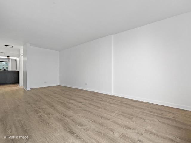 1221 N Dearborn St Unit 1401S, Chicago, IL 60610 - unfurnished living room with wood finished floors and baseboards
