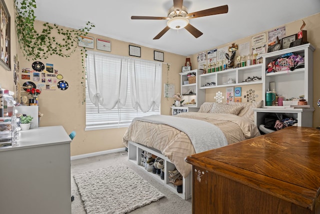 bedroom featuring baseboards, light carpet, and a ceiling fan