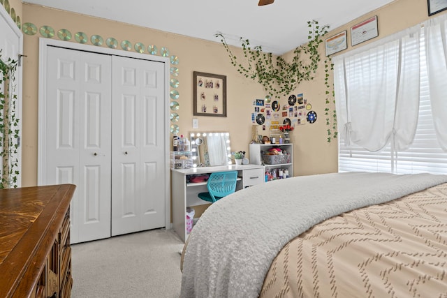carpeted bedroom featuring a closet, a ceiling fan, and multiple windows