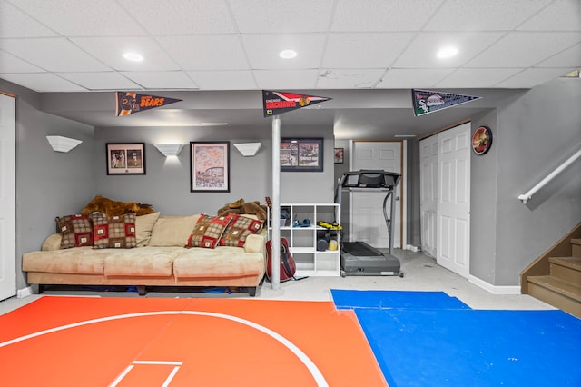 workout area featuring baseboards, recessed lighting, and a paneled ceiling
