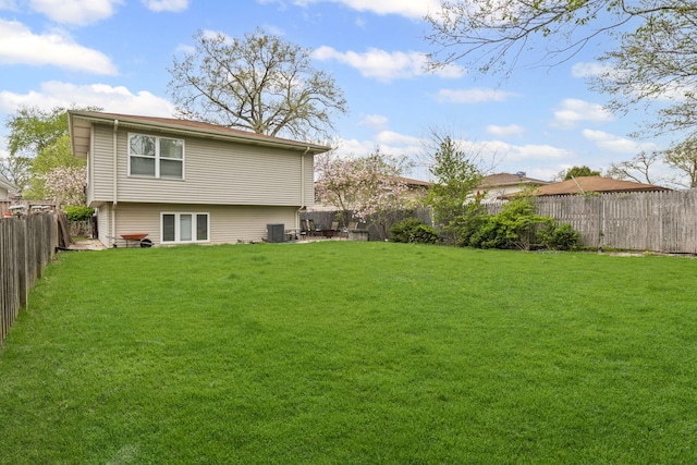 rear view of property with central AC