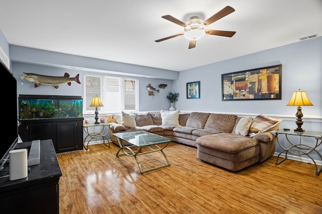 living area with ceiling fan and wood finished floors