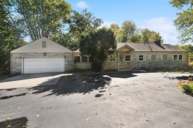 16937 W Jonathan Ln, Gurnee, IL 60031 - view of front of property featuring stone siding, driveway, and a chimney