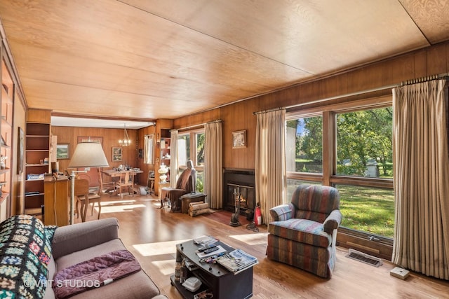 16937 W Jonathan Ln, Gurnee, IL 60031 - living room featuring wood walls, wood finished floors, a glass covered fireplace, and wood ceiling