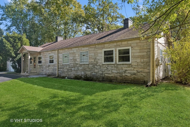 16937 W Jonathan Ln, Gurnee, IL 60031 - view of side of property featuring a chimney, stone siding, a lawn, and a shingled roof