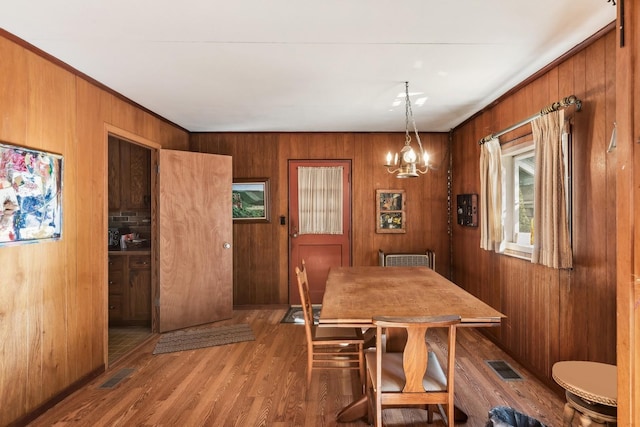 16937 W Jonathan Ln, Gurnee, IL 60031 - dining room featuring wood finished floors, a chandelier, and wood walls