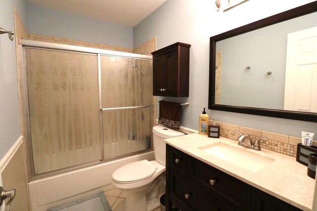 2210 Sandburg Dr, Aurora, IL 60506 - full bathroom with vanity, toilet, enclosed tub / shower combo, backsplash, and tile patterned floors