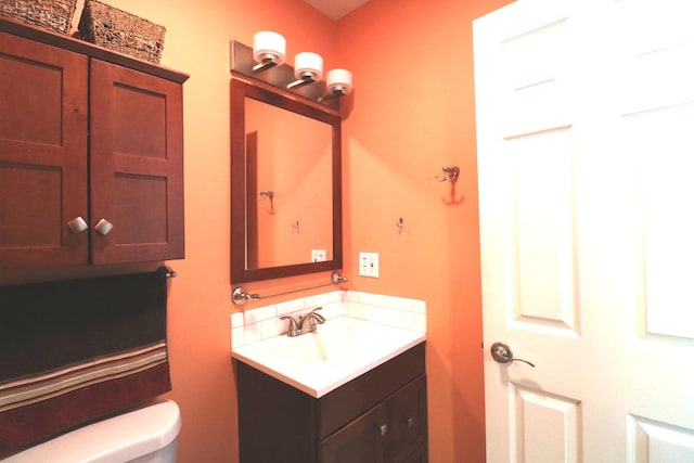 2210 Sandburg Dr, Aurora, IL 60506 - bathroom with vanity, toilet, and tasteful backsplash
