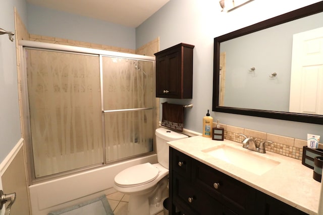 2210 Sandburg Dr, Aurora, IL 60506 - bathroom with vanity, toilet, tasteful backsplash, bath / shower combo with glass door, and tile patterned floors