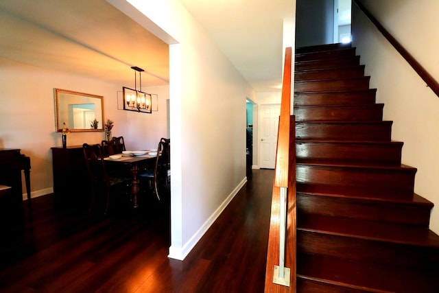 2210 Sandburg Dr, Aurora, IL 60506 - stairway with baseboards, wood finished floors, and a chandelier