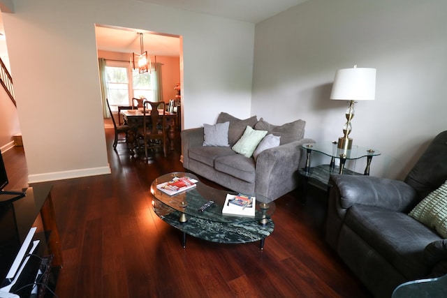 2210 Sandburg Dr, Aurora, IL 60506 - living room featuring wood finished floors, baseboards, a chandelier, and stairs