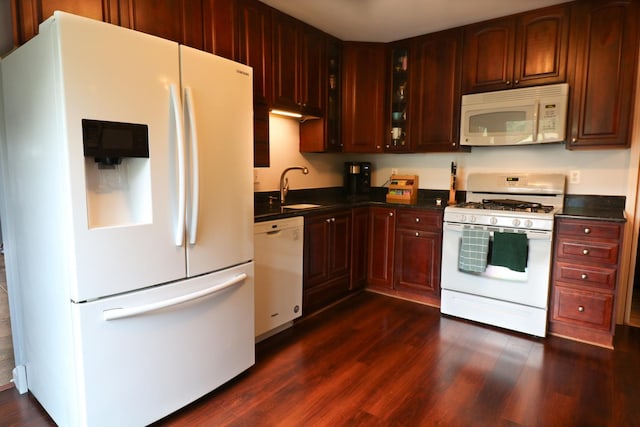 2210 Sandburg Dr, Aurora, IL 60506 - kitchen with white appliances, dark countertops, a sink, and dark wood-type flooring