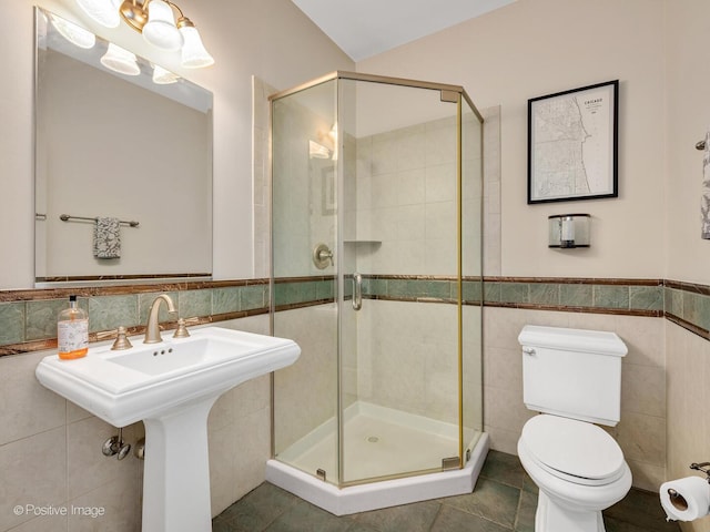 220 Kings Ct, La Grange Park, IL 60526 - bathroom with tile walls, a stall shower, toilet, a wainscoted wall, and tile patterned flooring