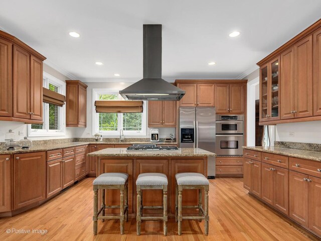 220 Kings Ct, La Grange Park, IL 60526 - kitchen featuring island exhaust hood, ornamental molding, stainless steel appliances, a kitchen bar, and a center island