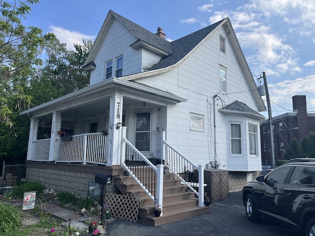 718 Plainfield Rd, Joliet, IL 60435 - view of front of home featuring a shingled roof, a porch, and a chimney