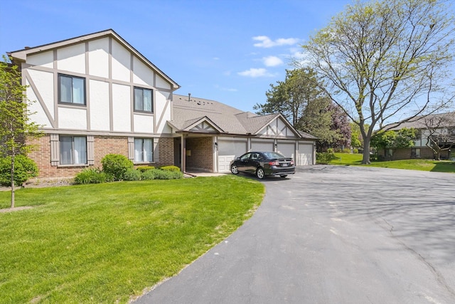 1010 E Kevin Ct Unit 1804, Palatine, IL 60074 - tudor house with an attached garage, driveway, brick siding, and a front yard