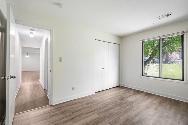 1010 E Kevin Ct Unit 1804, Palatine, IL 60074 - unfurnished bedroom with wood finished floors, a closet, and baseboards