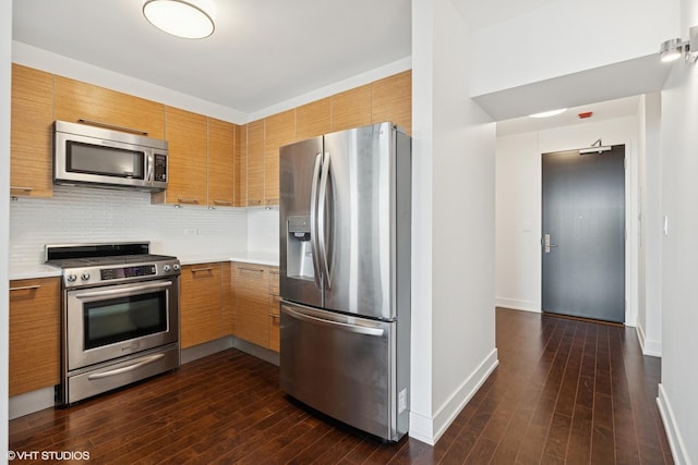 225 N Columbus Dr Unit 6204, Chicago, IL 60601 - kitchen featuring stainless steel appliances, light countertops, dark wood finished floors, and decorative backsplash