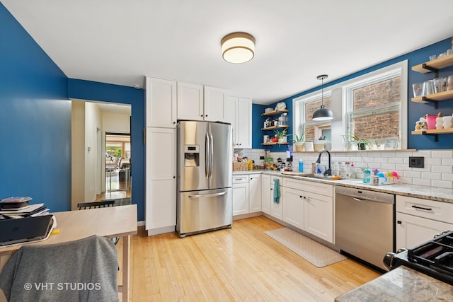 4842 N California Ave, Chicago, IL 60625 - kitchen featuring stainless steel appliances, open shelves, a sink, and backsplash