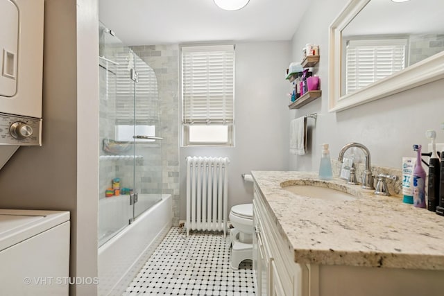 4842 N California Ave, Chicago, IL 60625 - full bathroom with radiator heating unit, toilet, vanity, and bath / shower combo with glass door