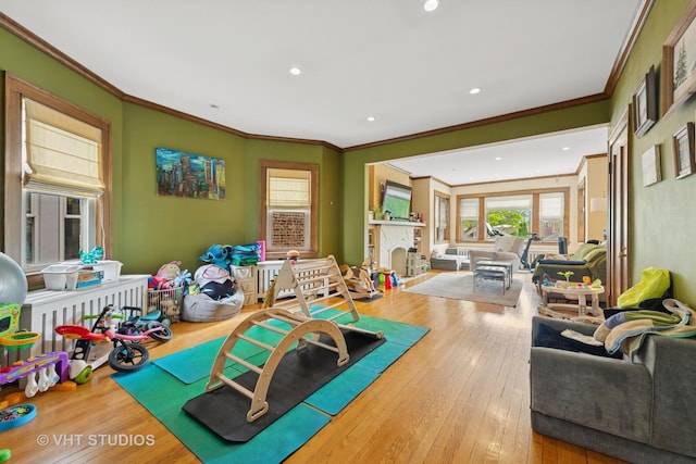 4842 N California Ave, Chicago, IL 60625 - rec room featuring ornamental molding, hardwood / wood-style floors, recessed lighting, and a fireplace