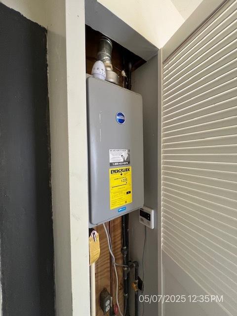utility room with water heater