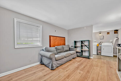 1144 N Austin Blvd, Oak Park, IL 60302 - living area with washer / dryer, light wood-type flooring, and baseboards
