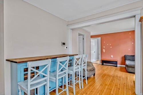 1144 N Austin Blvd, Oak Park, IL 60302 - dining space with light wood-type flooring, crown molding, and baseboards