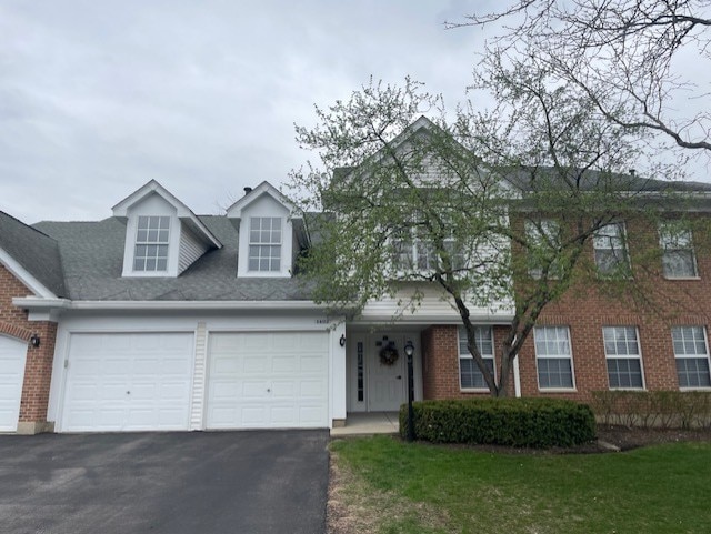 1402 Orange Ct Unit D, Mount Prospect, IL 60056 - view of front of property featuring asphalt driveway, a garage, and brick siding