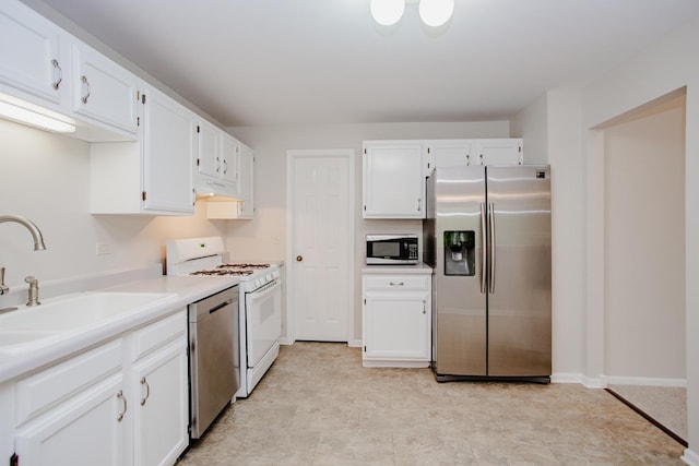 1402 Orange Ct Unit D, Mount Prospect, IL 60056 - kitchen featuring stainless steel appliances, a sink, white cabinets, light countertops, and under cabinet range hood