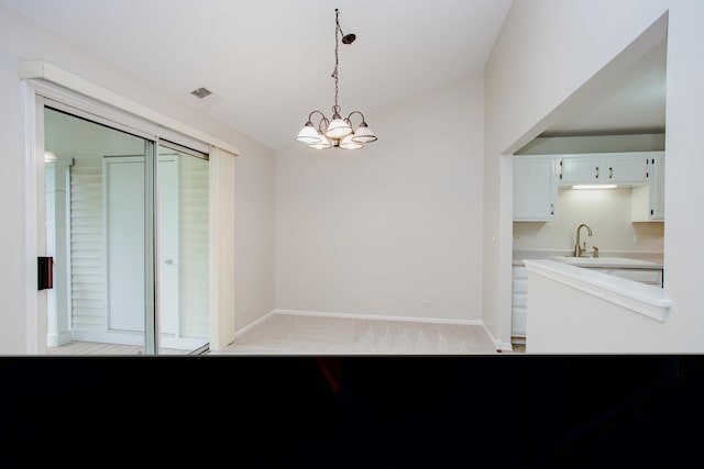 1402 Orange Ct Unit D, Mount Prospect, IL 60056 - unfurnished dining area with light carpet, baseboards, a chandelier, and a sink