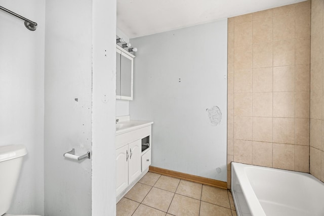 full bathroom featuring toilet, tile patterned floors, vanity, and baseboards
