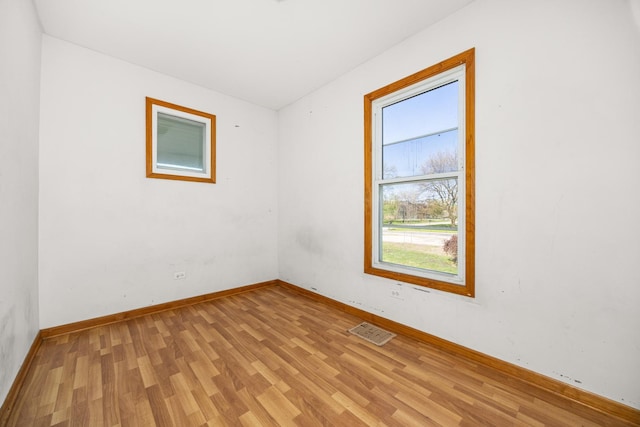 unfurnished room with light wood-style flooring and baseboards