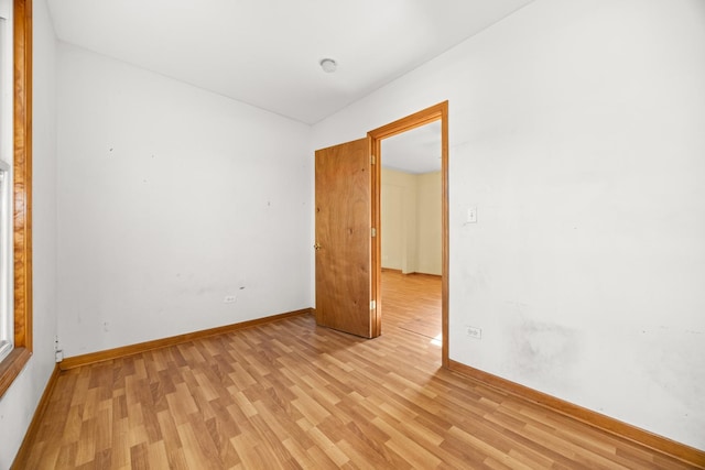 empty room featuring light wood-style floors and baseboards