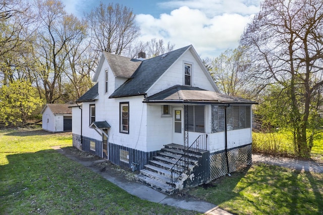 bungalow-style house featuring roof with shingles, a front yard, and a chimney