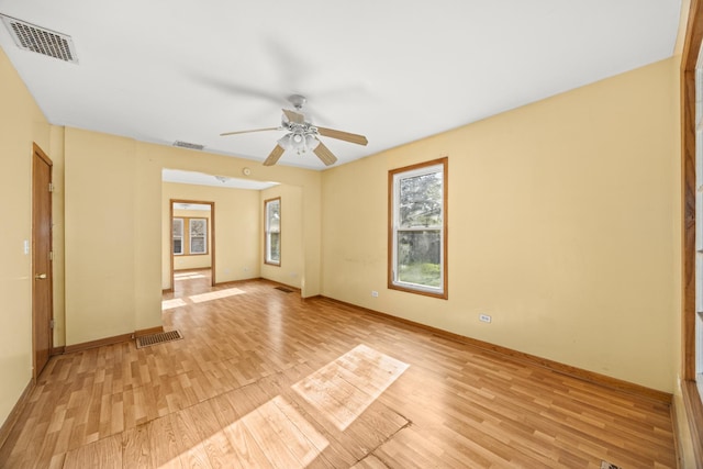 unfurnished room featuring light wood finished floors, baseboards, and ceiling fan