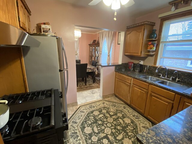 3846 Brummel St, Skokie, IL 60076 - kitchen with a sink, a ceiling fan, brown cabinets, and dark stone countertops